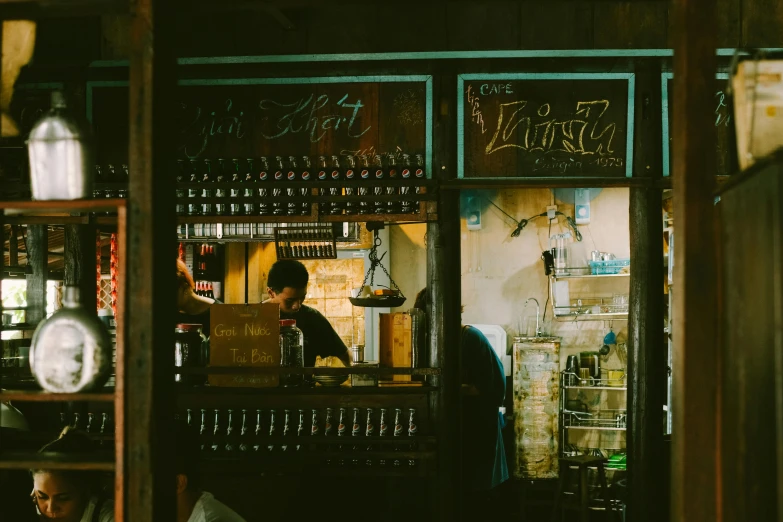 a bartender behind the bar in a dark room