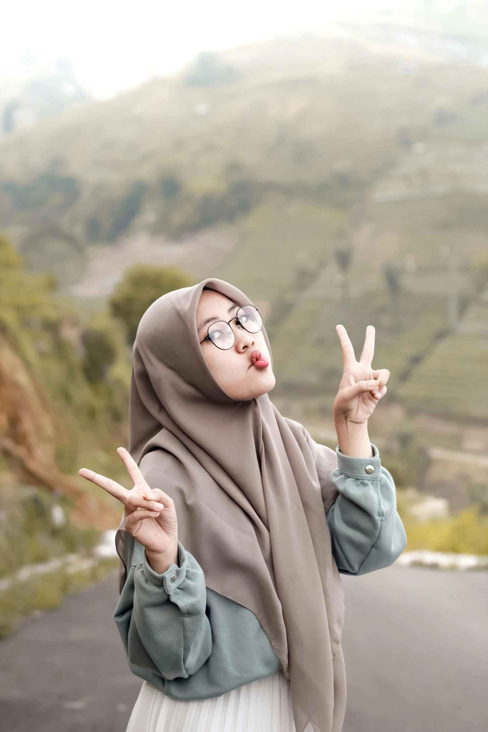 a woman posing for a picture wearing a hijab