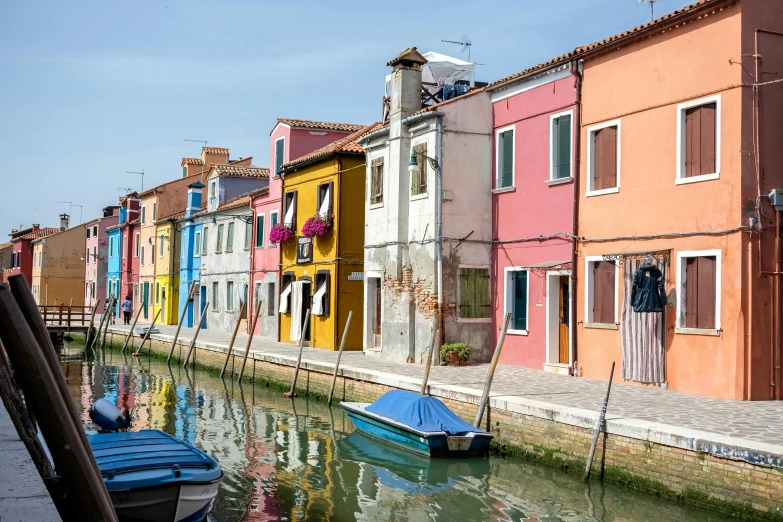 a row of colorful buildings next to a river