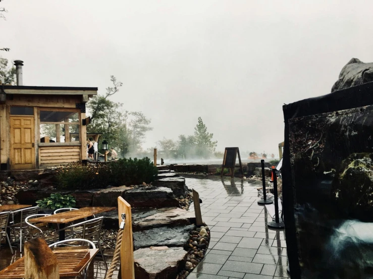 two wooden buildings on a rain covered street