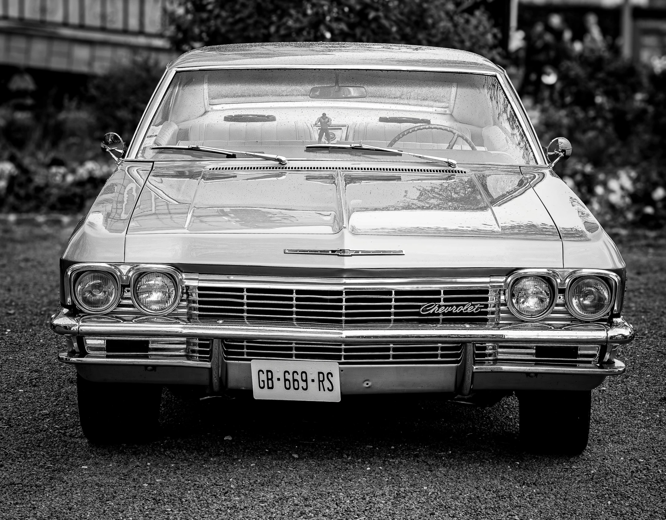 black and white po of a car with windshield broken down