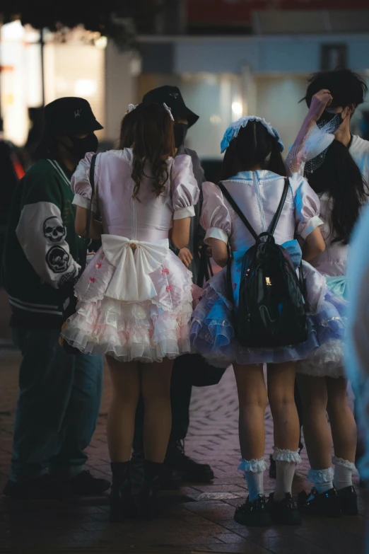 four s dressed up together on a cobblestone street