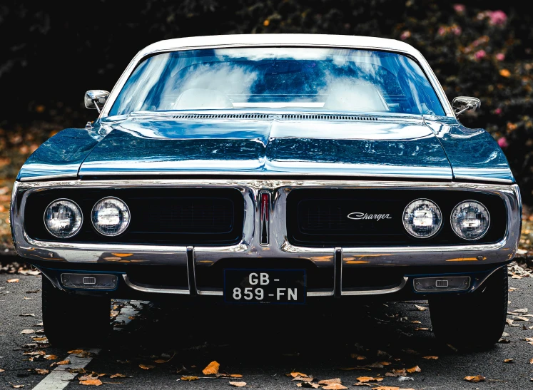 a very old car with some fog coming off of the front