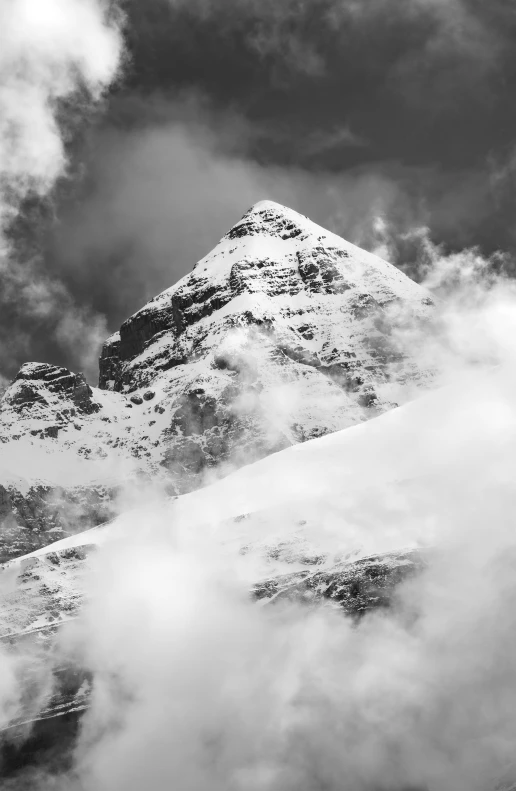 a mountain is shown with clouds around it