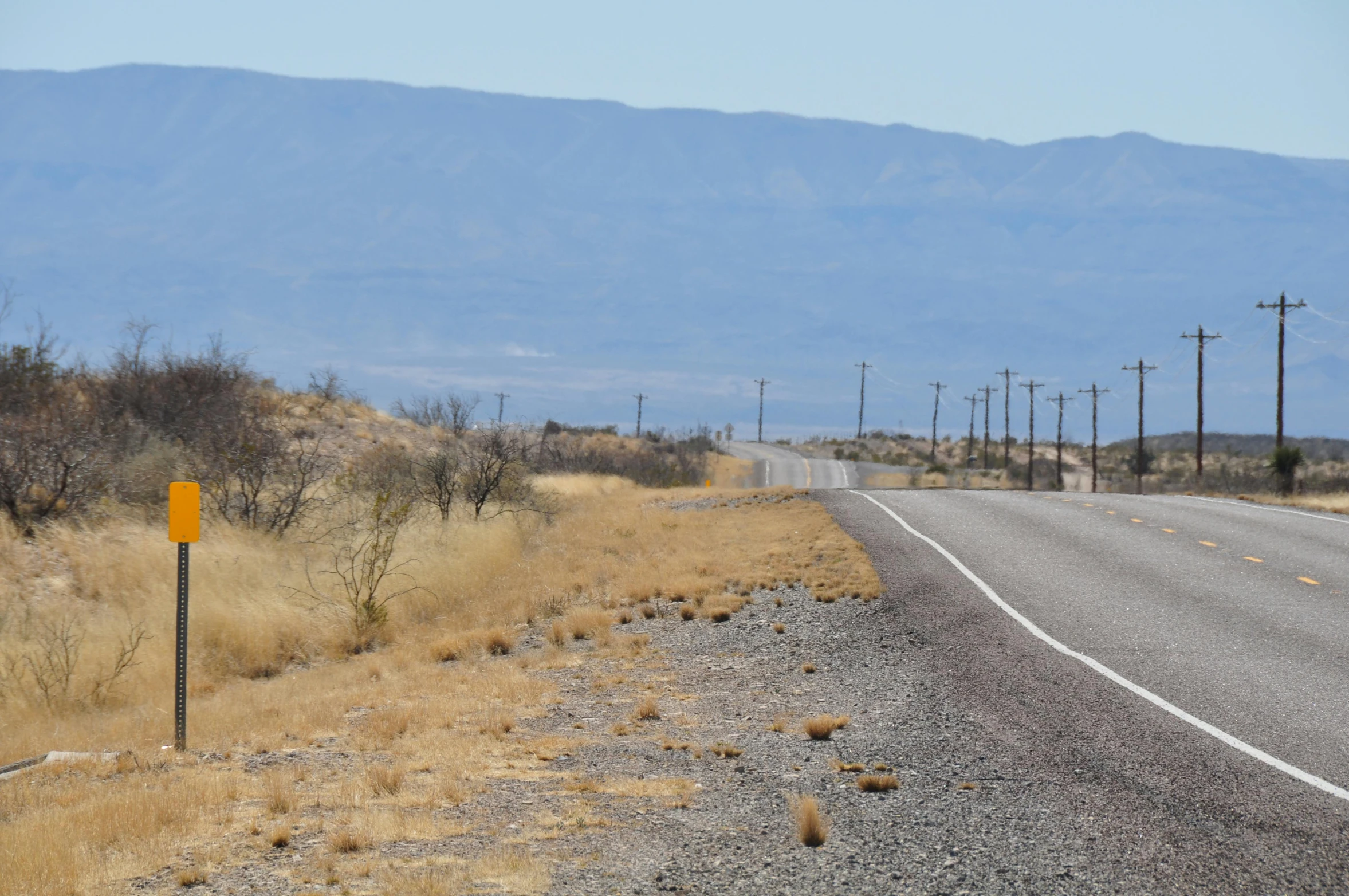 the road is empty with a few signs