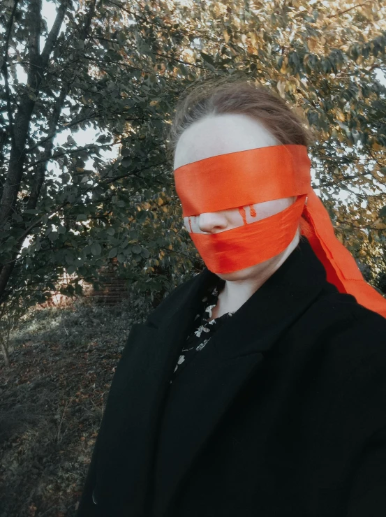 a woman wearing an orange mask with a ponytail