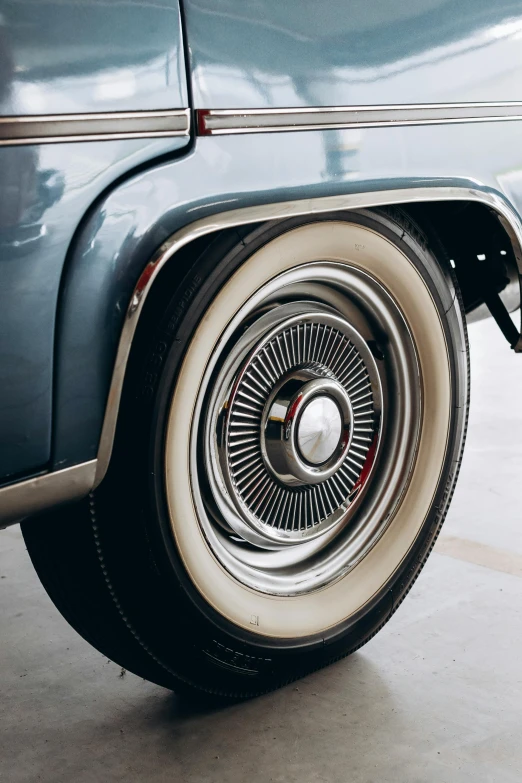 an old car with an old tire on it's flatbed