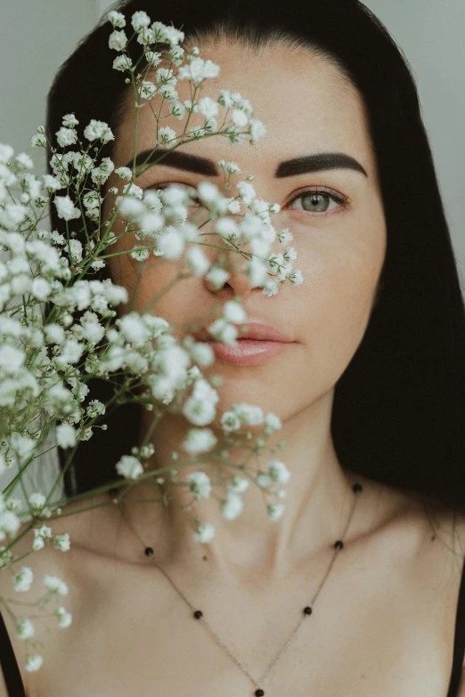 a close up of a person holding flowers