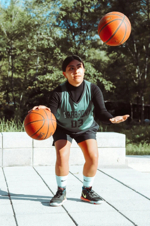 a boy is shooting at an orange basketball