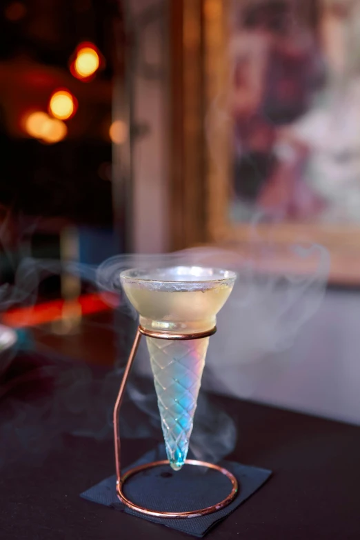 a small glass with water sitting on top of a black table