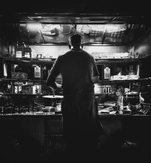 a chef looks through the shelves at soing else