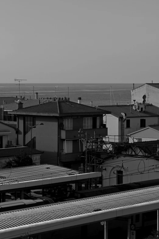 several roofs and a few houses on the shore