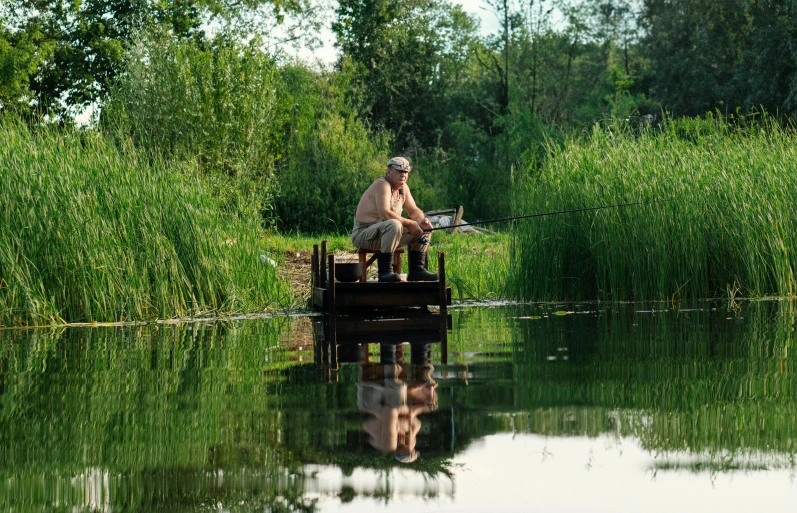 the fisherman is fishing for small fish on the lake