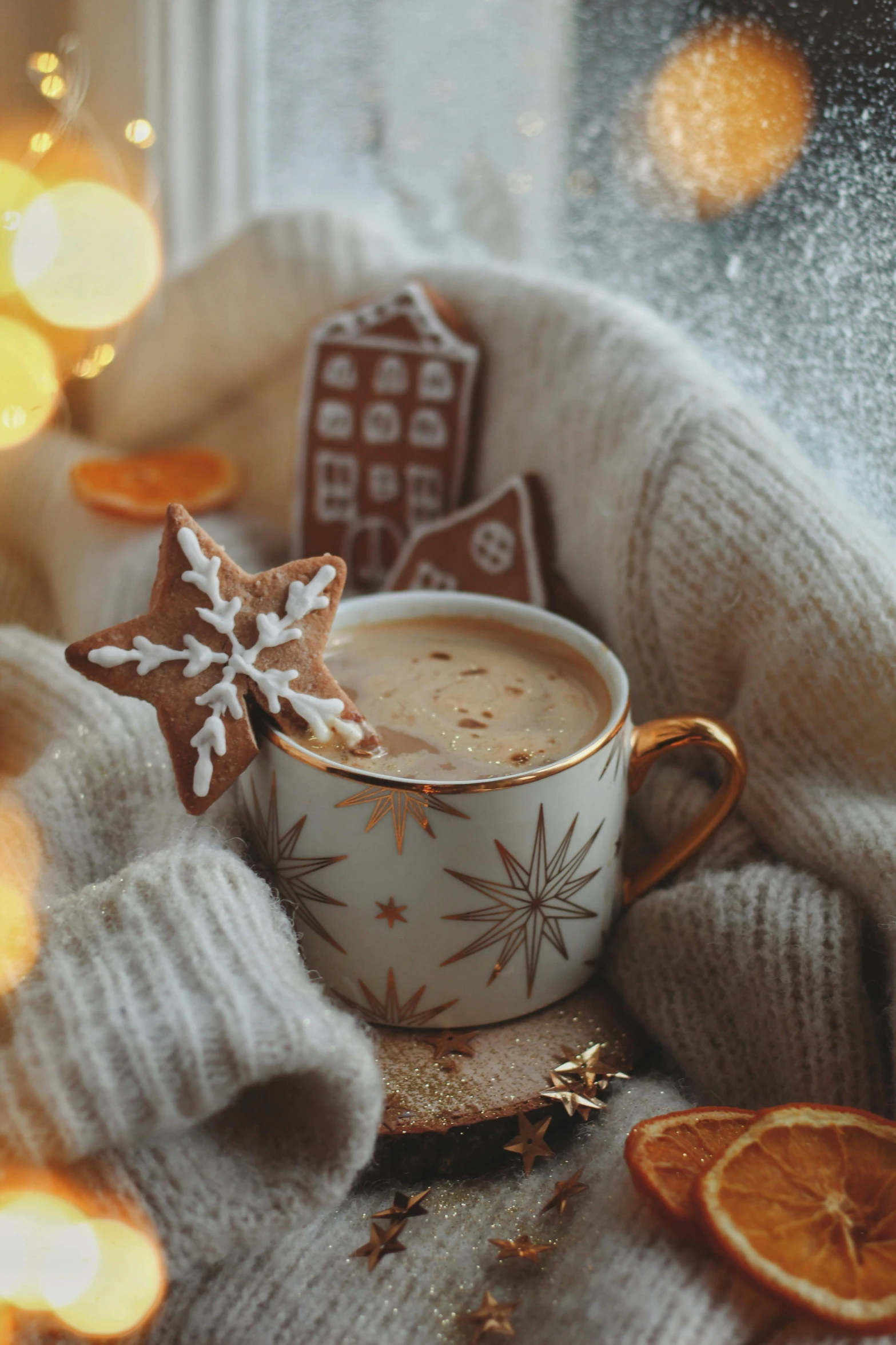 a cup of coffee surrounded by some orange slices