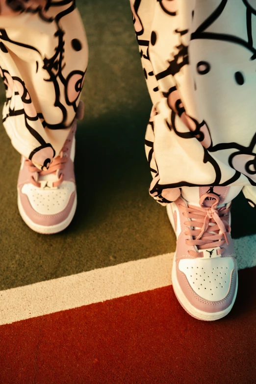 a persons feet wearing hello kitty clothing on a floor