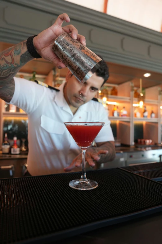 a man is mixing a drink at a bar