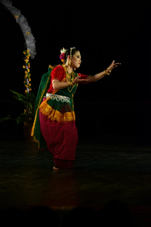 the person is dressed in indian attire and is dancing