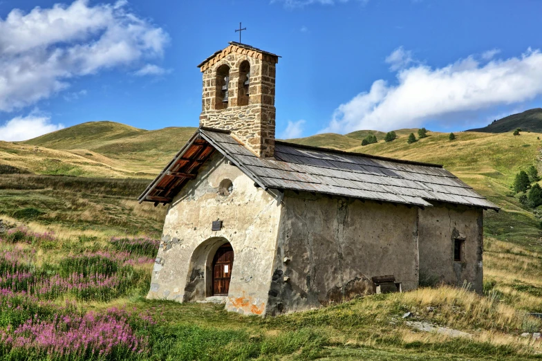 an old abandoned church in a grassy field