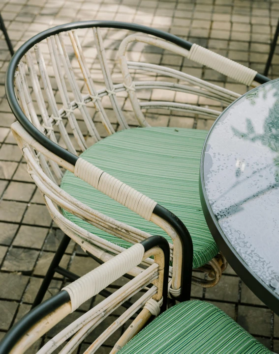 two chair and one table with cushions on bricks