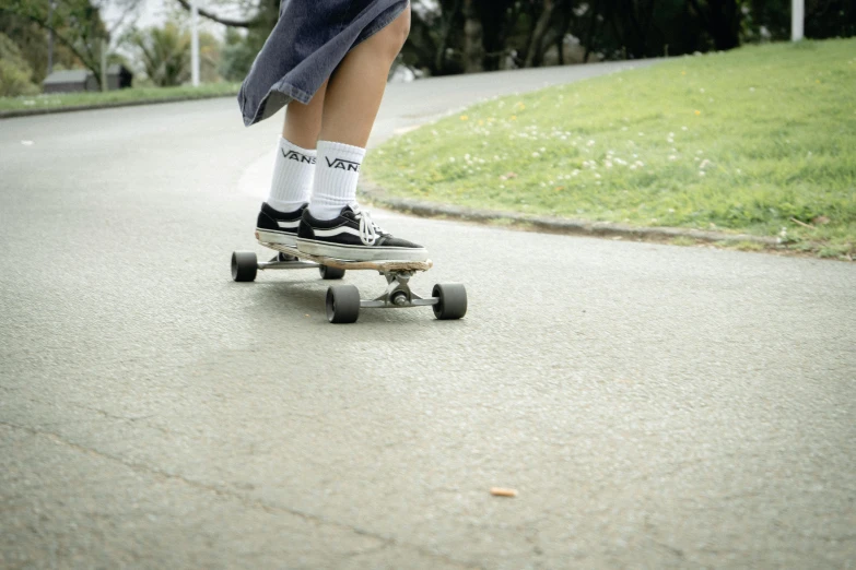 a person on a skateboard is riding down the street