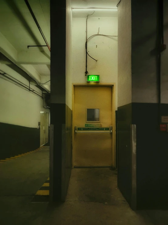 this is an elevator in a building with an exit sign