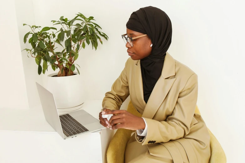 a woman in a hijab sitting on a chair