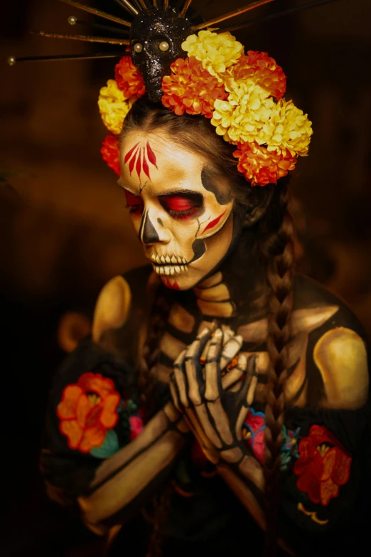 a woman wearing a skeleton make up with flowers on her head
