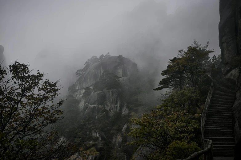 dark misty hillside area with steps leading to a cliff