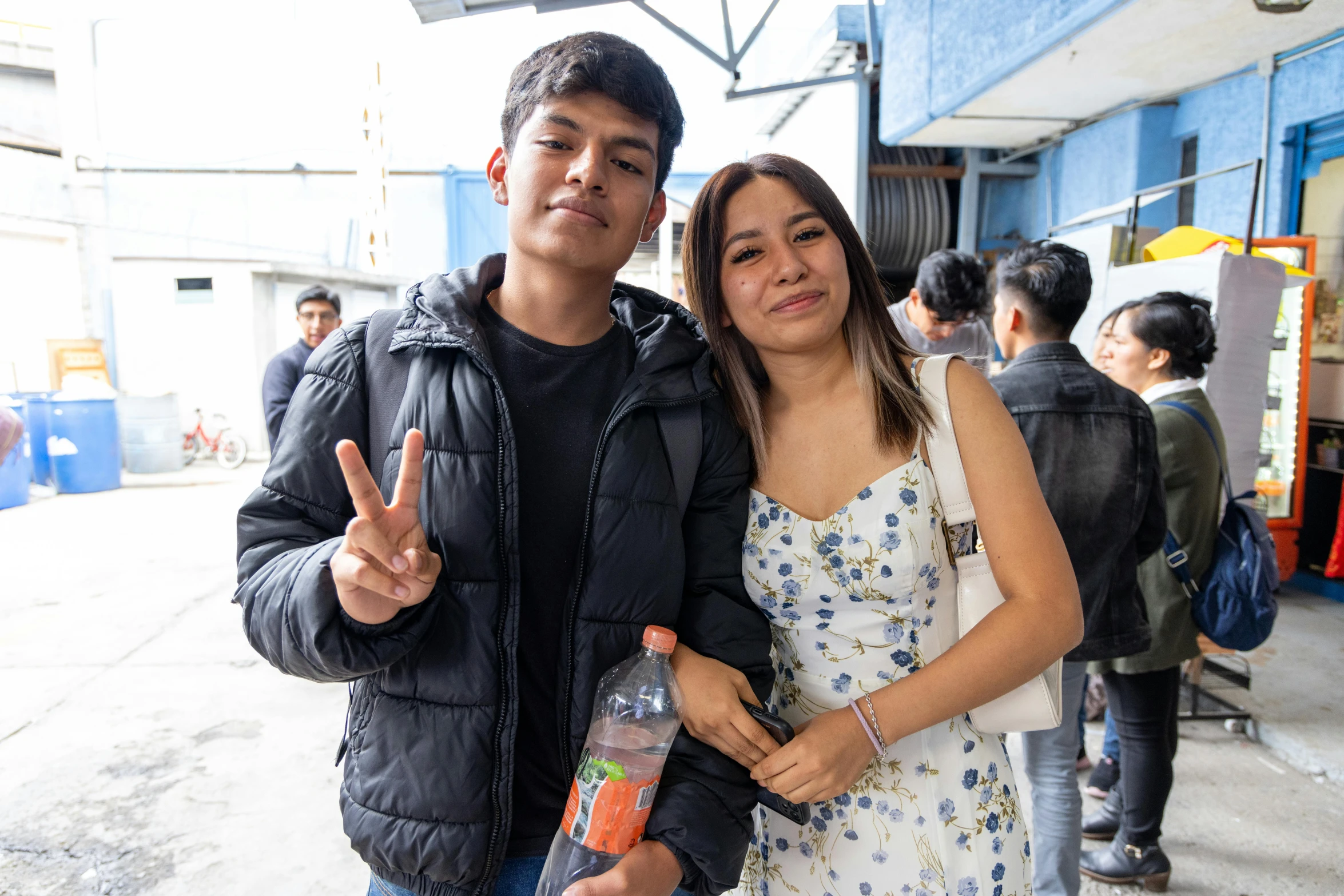 a man and woman standing in front of some people