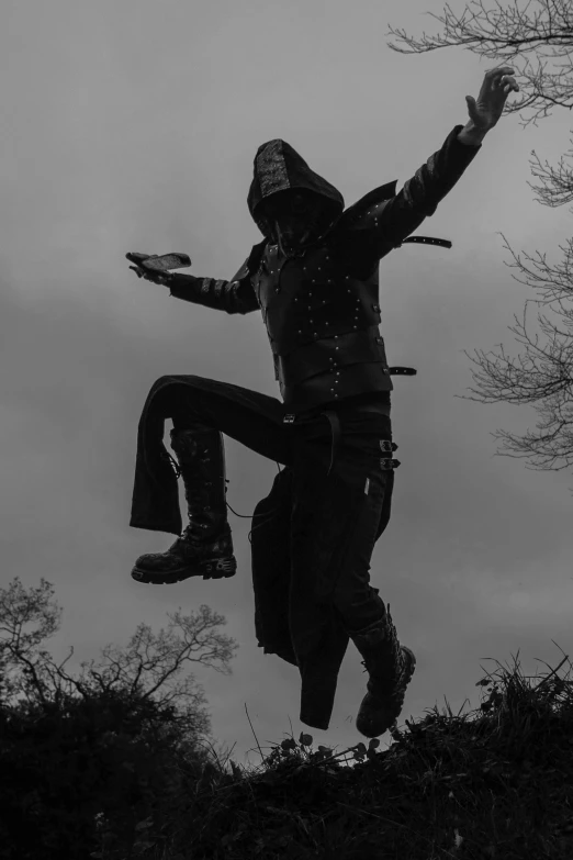 a man in black is walking on a snowy hill