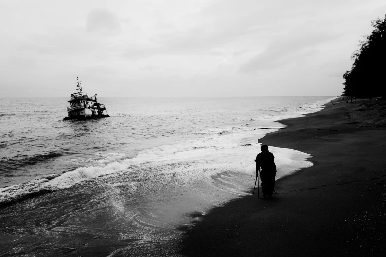 an old boat with a ship behind is approaching a shore