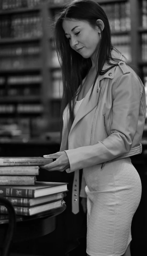 this woman is looking at a book and pointing to it