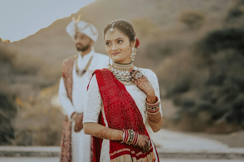 an indian couple is smiling for a wedding po