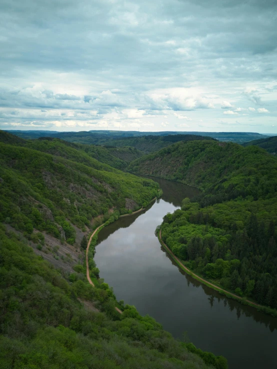 a lake surrounded by hills and greenery