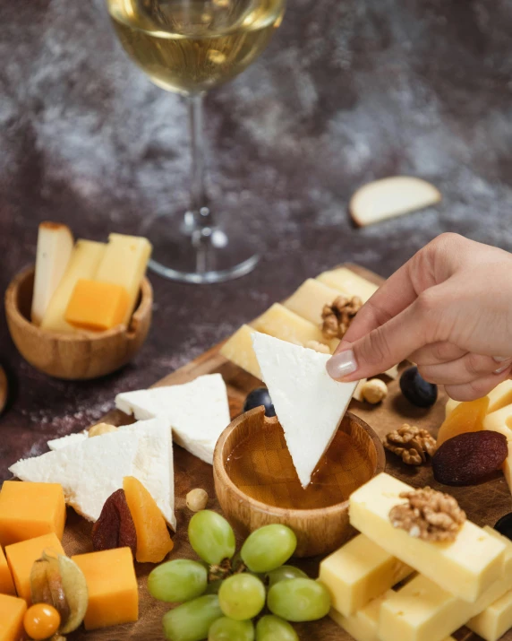 a platter with some cheeses and a bottle of wine