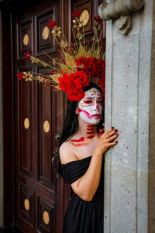 woman in black dress with mask posing for picture