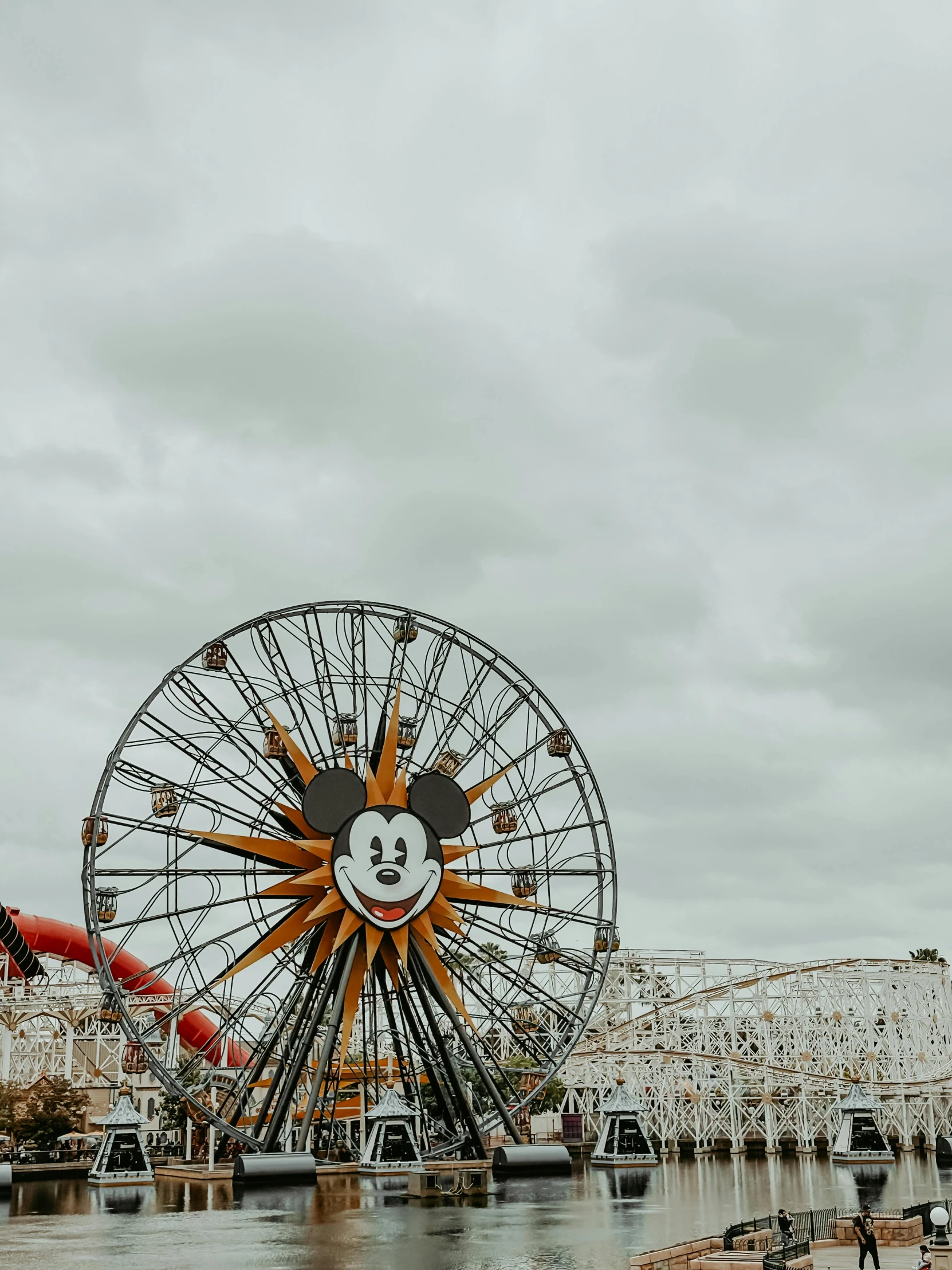 a ferris wheel near some other rides at a carnival