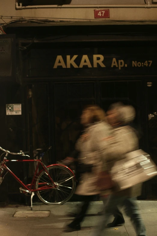 some people are walking past a store on the sidewalk