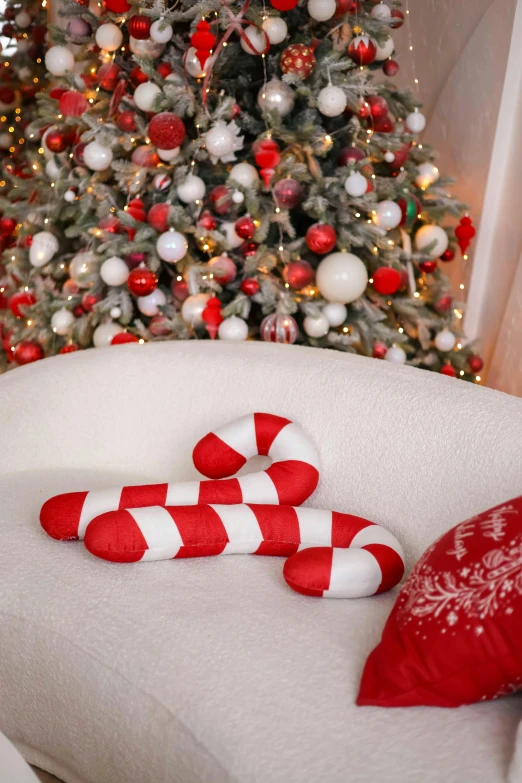 a christmas tree and a red and white candy cane on a chair