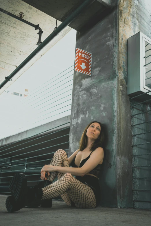 woman with , and pant sitting on a wall