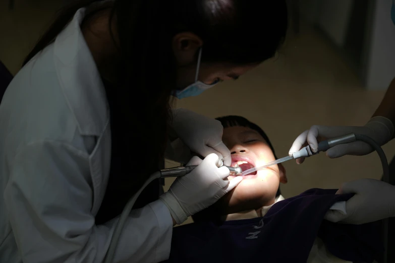 there is a woman smiling and getting ready to receive an infant toothbrush