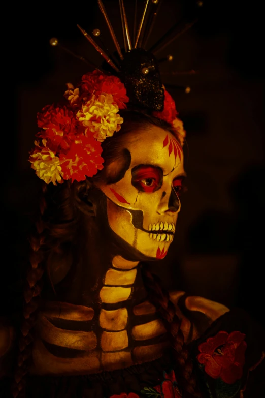 a painted skeleton wearing a head piece and flowers