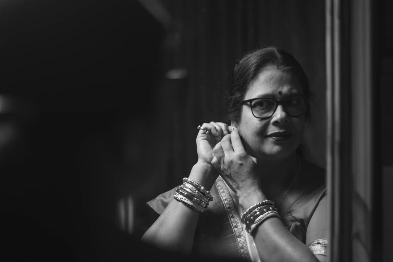 a person is standing in front of a mirror and wearing glasses