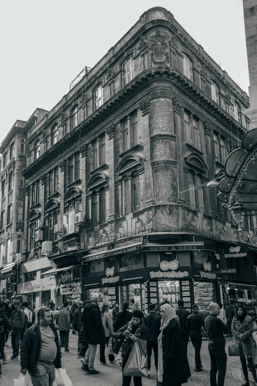 a crowd is gathered around in front of old buildings