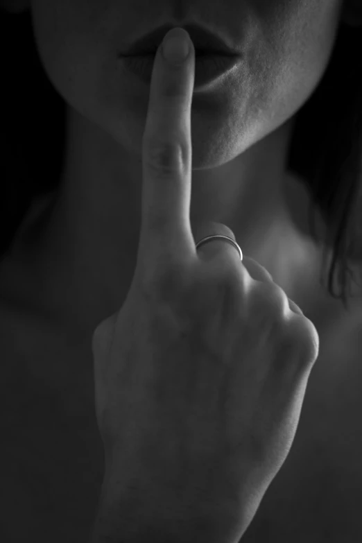 a woman pointing her finger at soing in front of her