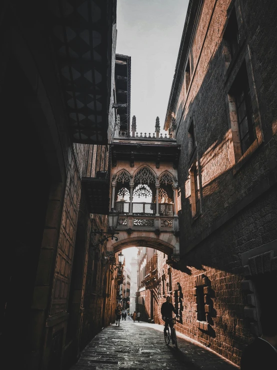 a couple walking down a narrow walkway between two buildings