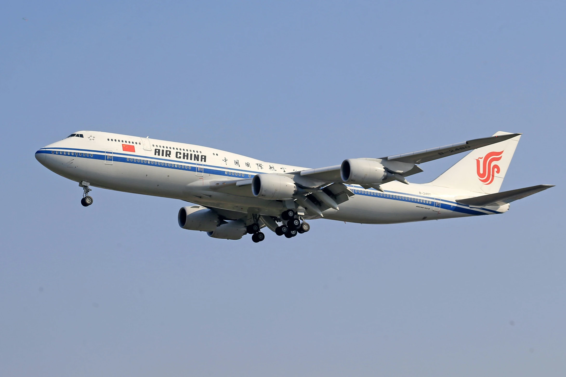 an airplane flies thru the blue sky on its first day