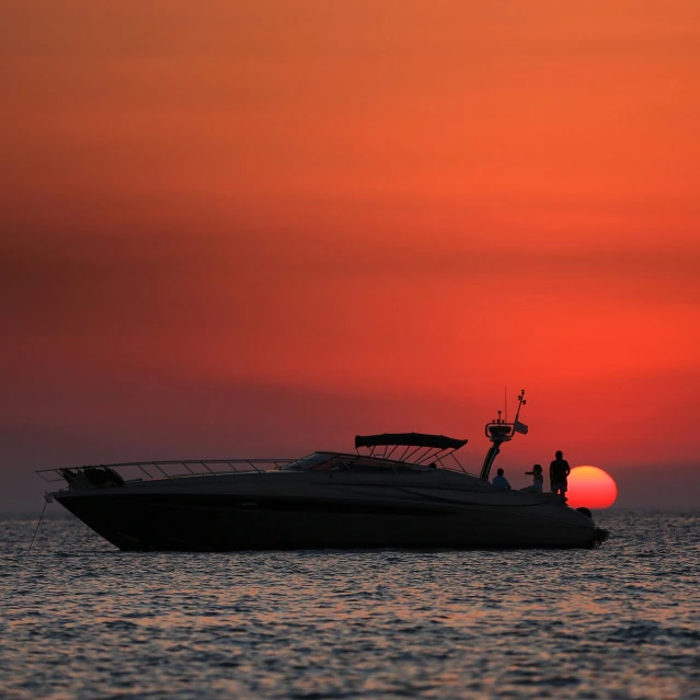 a big boat out in the water at sunset