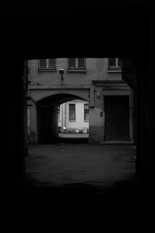 a small white bus parked under an overpass