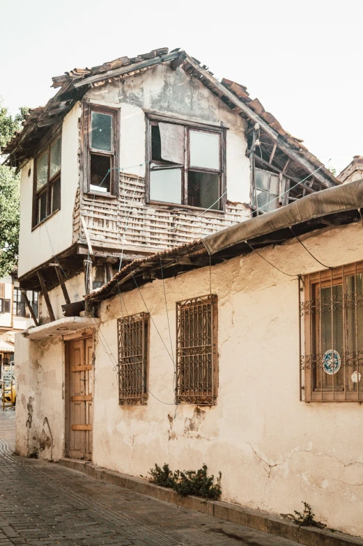 an old building with a lot of windows and bars